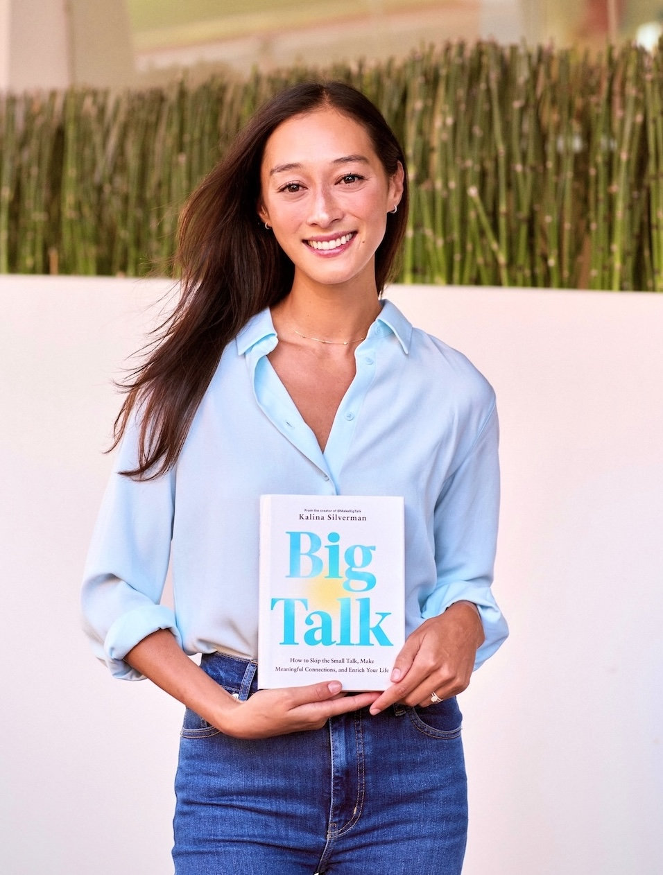 Kalina holding a copy of her book, Big Talk